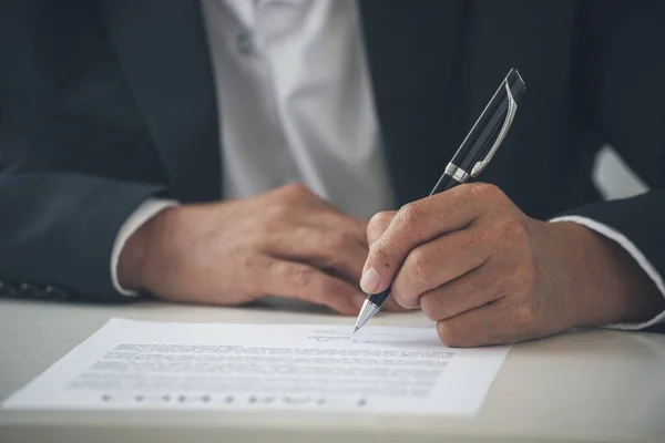 Businessman hand using pen signing on new contract starting projects in conference room. Close up business manager man hands sign contract legal document in meeting room. Business agreement concept