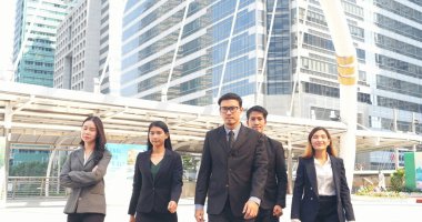 Portrait Group of businesspeople arms crossed smiling look at camera in modern city background. Happy Businessman, businesswoman teams partnership. Business people teams positive teamwork standing.