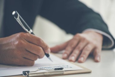 İş adamı, konferans odasında yeni sözleşme imzalamak için kalem kullanıyor. İşletme müdürü toplantı odasında kontrat imzaladı. İş anlaşması kavramı