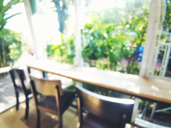 Blurry background interior design bar table chair window decorate indoors space display. Blurred background cafe coffee shop restaurant in shopping mall with light bokeh business event retail store