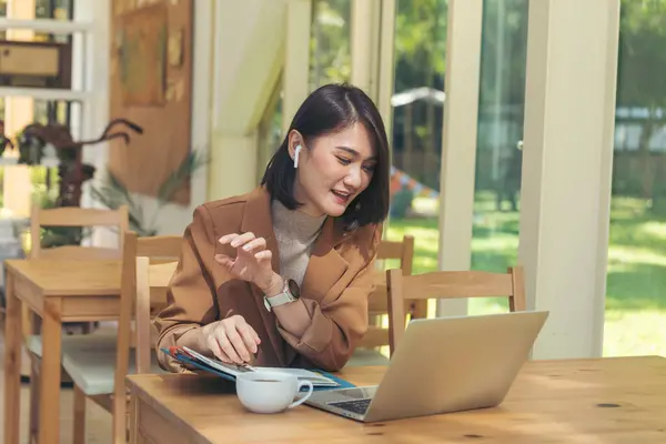 Woman typing laptop computer online meeting at home office work from home. Asian business woman using notebook laptop lifestyle. Happy programmer woman typing keyboard laptop read online website