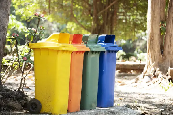 Trash cans for sorting garbage recycle bin waste plastic container collection. Reuse, reduce, recycle sorting process sustainable lifestyle rubbish dustbin plastic box in green garden.