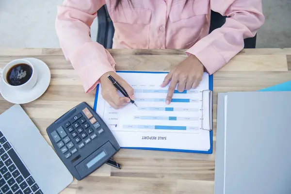 Woman Hands working home do accounting small business. Audit Businesswoman at office desk. Close up businesswoman hands audit accountant using calculator, business graph chart working at home office.