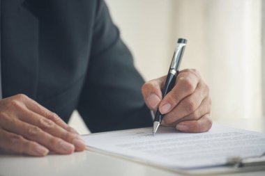 Asian business man using pen signing on new contract to starting projects in conference room. Close up manager businessman hands sign contract working meeting. Business agreement concepts.