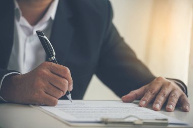 Asian business man using pen signing on new contract to starting projects in conference room. Close up manager businessman hands sign contract working meeting. Business agreement concepts.