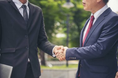 Diversity Business Partner meeting trust in teamwork and partnership businessman, businesswoman talking together in modern city. Asian coworker team meeting with Business People Working Together Team