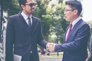 Diversity Business Partner meeting trust in teamwork and partnership businessman, businesswoman talking together in modern city. Asian coworker team meeting with Business People Working Together Team