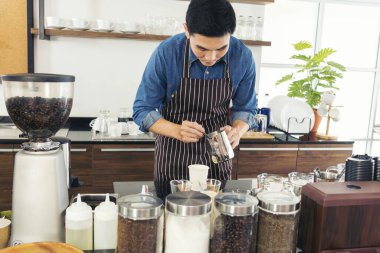 Close up hands coffee barista man make hot cup espresso shot from coffee machine. Cappuccino with milk in italian coffee shop cafe. Close up hands of barista use machine make black drinking hot cup