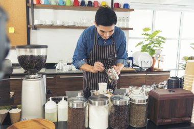 Close up hands coffee barista man make hot cup espresso shot from coffee machine. Cappuccino with milk in italian coffee shop cafe. Close up hands of barista use machine make black drinking hot cup