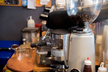Close up hands coffee barista man make hot cup espresso shot from coffee machine. Cappuccino with milk in italian coffee shop cafe. Close up hands of barista use machine make black drinking hot cup