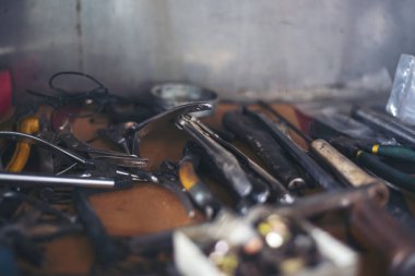 Mekanik aletler, araba tamirhanesi ve fotokopi alanı. Bulanık arkaplan mekanik servisi. Ağır vida paslı anahtarlar kirli tornavida nesneleri. Endüstriyel donanım