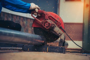 Kaynak makinesi demir metal kıvılcım saçıyor. Kızgın alev kaynağı metal işçiliği ateş demir atölyesini kesiyor. Çilingir kaynak makinesi kullanarak metal işleme makinesini kesiyor. Metal işçiliğinde kıvılcımlar