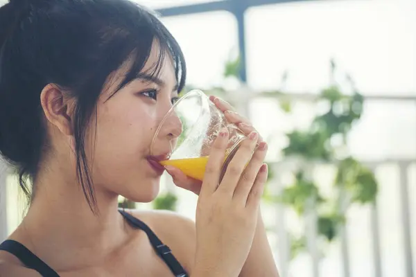 stock image Women hands holding cold orange juice fresh fruit cool drinking. Asian women smile laugh look at camera health care home fitness lifestyle. Beautiful female pouring orange juice from cocktail bottle