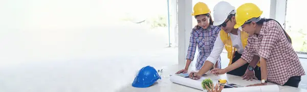 Banner asian engineer man brainstorming teams partner meeting office desk on construction site. Architecture civil Engineer contractor manager team meeting together. Teamwork business with copy space
