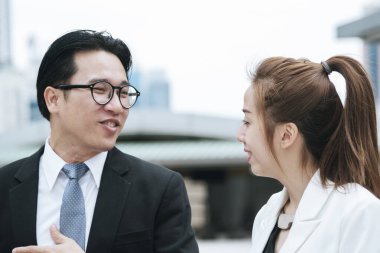 Diversity Business Partner meeting trust in teamwork and partnership businessman, businesswoman talking together in modern city. Asian coworker team meeting with Business People Working Together Team clipart