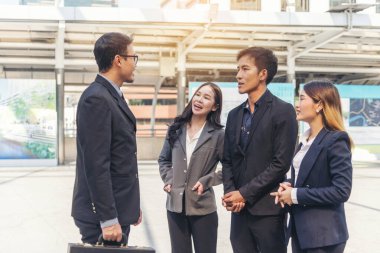 Diversity Business Partner meeting trust in teamwork and partnership businessman, businesswoman talking together in modern city. Asian coworker team meeting with Business People Working Together Team