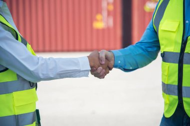 Close up warehouse worker shakehand together. Engineer man hands partnership. Diversity Coworker Men logistics Warehouse teams handshake. Multiracial Support team greeting person teamwork colleagues clipart