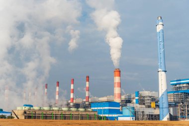 Elektrik santralleri elektrik endüstrisi üretiyor. Elektrik santrali rafinerisi mühendisliği buhar bacası. Linyit elektrik bacaları endüstride kirliliği serbest bırakır mavi gökyüzü