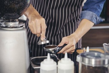 Close up hands coffee barista man make hot cup espresso shot from coffee machine. Cappuccino with milk in italian coffee shop cafe. Close up hands of barista use machine make black drinking hot cup