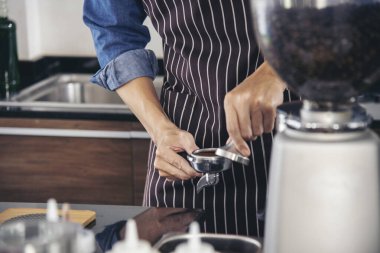 Close up hands coffee barista man make hot cup espresso shot from coffee machine. Cappuccino with milk in italian coffee shop cafe. Close up hands of barista use machine make black drinking hot cup