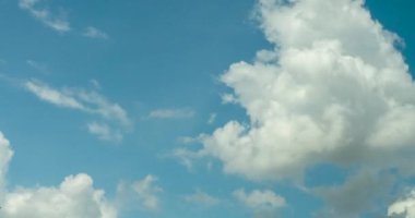 Timelapse Mavi gökyüzü, yaz mevsiminde pofuduk beyaz bulutlar parlak gökyüzü, güzel bulutlu bir hava çizgisi. Zaman çizelgesi mavi gökyüzü gökyüzünü gün ışığında fotokopi uzayı ile bulutlandırır. Bulutlu güneşli bir gün.