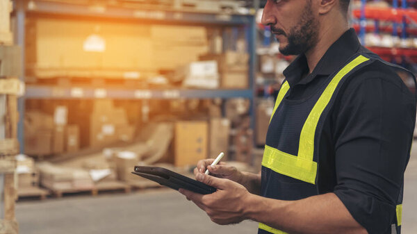 Close up Hispanic men hands using pen touch smart tablet Warehouse management logistics counting checking products on inventory shelf. Man hands worker check stock control in distribution storage