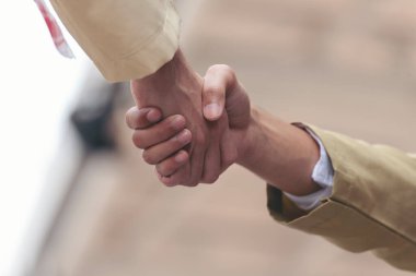 Arab Businessman shaking hands together. Teamwork business partner wear Muslim dress Shake Hands with Partnership Concept. Success UAE diversity people trust make commitment by handshake