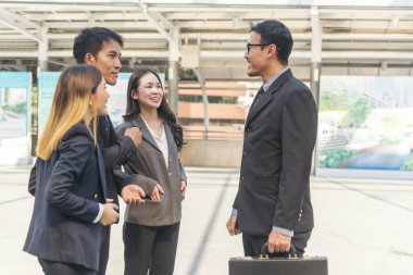 Diversity Business Partner meeting trust in teamwork and partnership businessman, businesswoman talking together in modern city. Asian coworker team meeting with Business People Working Together Team