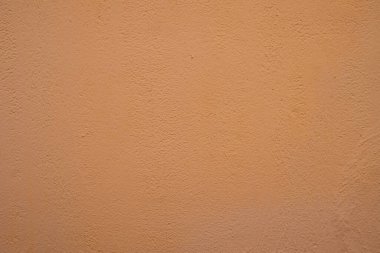 Orange concrete wall texture, close up photo.