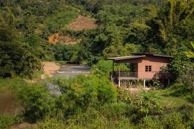 House in the jungle, next to a river in Thailand