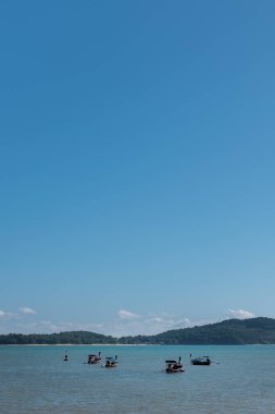Group of long-tail boats in the sea. Tropical seascape from Ko Lanta, Thailand with copy space