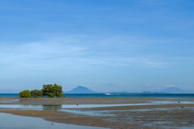 Tropical beach at low tide in Ko Lanta Island with speedboat in the background , Krabi, Thailand.