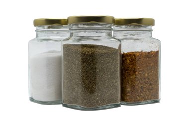 Three glass jars with spices. Celery seeds, salt and chili powder. Isolated on white background with clipping path.