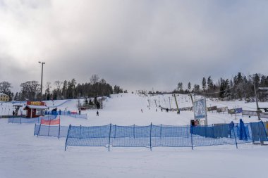 People skiing at the Messila Ski Resort in winter. Hollola, Finland. February 7, 2023.