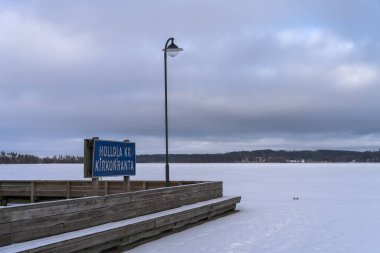 Hollola KK, kirkonranta port in winter. Sign and landscape from Hollola , Finland. February 7, 2022.