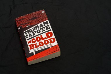 In Cold Blood by Truman Capote, on dark surface. Lahti, Finland. June 18, 2023. clipart
