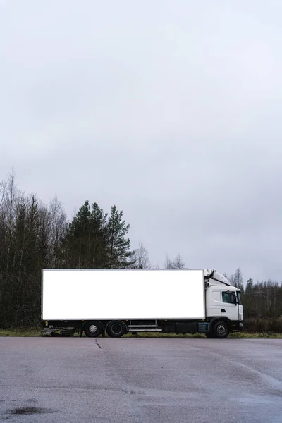 White lorry parked on a cloudy day. Mock up with clipping path.