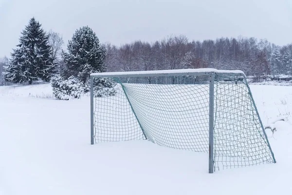 Soccer goal outdoors, covered with snow in winter.