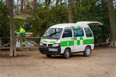 Madrid, Spain. February 12, 2024 - A green and white maintenance van belonging to park workers at El Retiro Park clipart