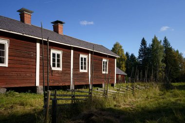 Historic house and old wooden fence in Kovero Heritage Farm in Seitseminen National Park. Ikaalinen, Finland clipart