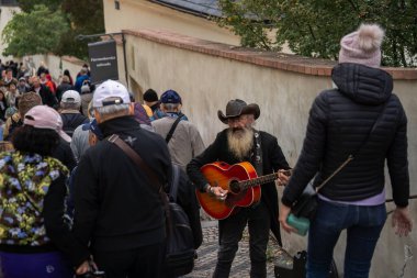 Prag, Çek Cumhuriyeti. 4 Ekim 2024 - Prag Kalesi 'ne çıkan Castle merdivenlerinde sokak müzisyeni