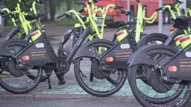 Lahti, Finlandiya. 13 Temmuz 2025 - Park halindeki Mankeli kiralık bisikletleri bir bisiklet istasyonunda dizildi