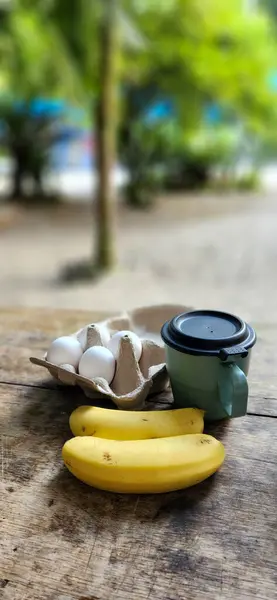 stock image breakfast with tropical fruits in the middle of nature with two coffee mugs