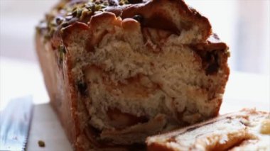 Zoom out of Homemade braid bread babka on cutting board