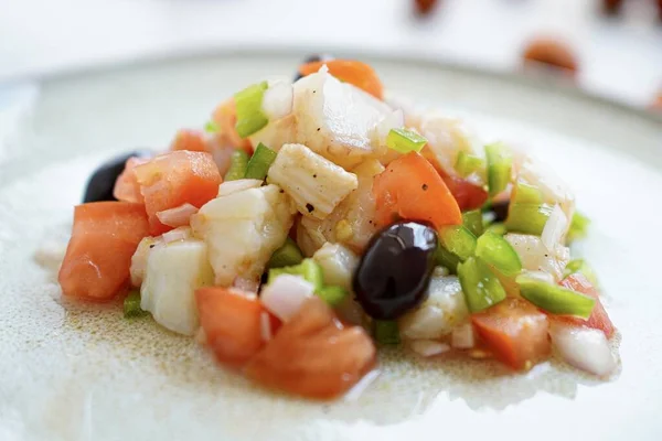 Esqueixada, Cod fish salad with tomato and onion, olives , typical Catalan dish, Barcelona, ,Spain