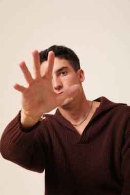 Mental health. Young man with serious expression, posing indoor. Vertical. High quality photo.