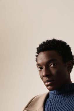 Young African American man looking at the camera. Vertical mock-up. High quality photo.