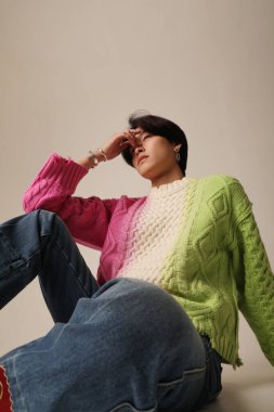 Confident young Asian man posing indoor over white background. Vertical. High quality photo.