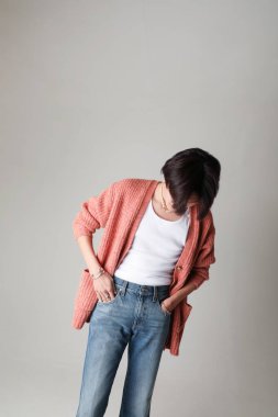 Young man looking down and posing indoor over white background. Mock-up. High quality photo.