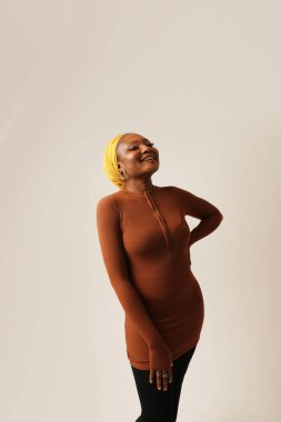 Happy muslim black woman wearing formal black shirt and hijab posing indoor. Vertical. High quality photo.